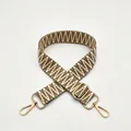 Close-up of brown and white herringbone woven strap with adjustable gold metal buckle - Khaki
