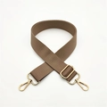 Close-up of brown nylon bag strap with high-density texture and gold metal hooks - Khaki