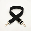 Close-up of adjustable black nylon bag strap with polished light gold metal hooks - Black