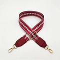 Close-up of burgundy herringbone patterned bag strap with golden metal lobster clasps - Burgundy