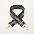 Detail of adjustable wide shoulder strap with black white pixel grid and gold metal buckle - Black Grey Stripe Gold Buckle
