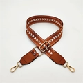 Detail of adjustable caramel brown woven strap with white V-pattern and gold hardware - Brown
