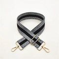 Close-up of adjustable wide shoulder strap with grey white polka dots and gold metal buckles - Grey With Gold Buckle