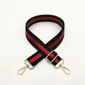Detail of adjustable black and red striped bag strap with gold metal lobster clasps - No. 1 Black Red Stripe