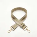 Close-up of beige woven adjustable shoulder strap with gold glitter and lobster clasps - No. 4 Cream White