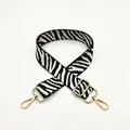 Detail of zebra pattern shoulder strap with gold hardware and lobster clasps - No. 12 White Zebra
