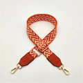 Detail of adjustable PU leather bag strap with orange and white V-shaped chevron pattern - Orange