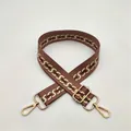 Detail of adjustable brown shoulder strap with beige S-pattern weaving and gold hardware - Pink S-Chain