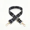 Detail view of black and white checkered woven strap with adjustable gold lobster clasps - No.7 Black White Plaid