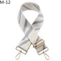 Close-up of zebra pattern woven canvas bag strap with golden metal lobster clasps - Gray Striped / Silver Buckle