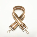 Detail view of adjustable striped bag strap with gold metal hooks and coffee-white tones - Khaki