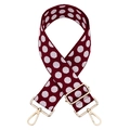 Close-up of red-brown polka dot thick jacquard strap with gold-tone metal hardware - Burgundy