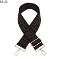 Macro detail of brown geometric maze pattern woven bag strap with gold metal buckles - M-21 Coffee