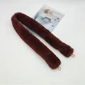 Detail showing plush faux fur shoulder strap in reddish brown with gold lobster clasps - Brown