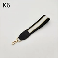 Detail of striped black and white bag wristlet strap with gold metal spring buckle - Black Gold Black Stripe