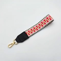 Close-up of pink checkered woven handbag strap with gold metal lobster clasp - No.5 Orange Weave + Black Leather