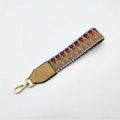 Detail of bohemian woven strap with purple patterns and golden lobster clasp - No.3 Khaki Weave + Khaki Leather / Silver Clasp