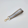 Close-up of khaki woven strap with silver glitter stripe and champagne gold lobster clasp - Khaki