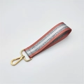 Detail showing red glitter webbing wrist strap with golden metal lobster clasp - Silver Clasp / Pink