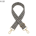 Detail of adjustable geometric patterned bag strap with golden metal lobster clasps - Black