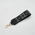 Dettaglio del cinturino etnico jacquard con motivo floreale e chiusura in metallo dorato - Chiusura in Argento / Floreale Verde Su Nero