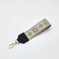 Close-up of ethnic style embroidered strap with green floral patterns and gold lobster clasp - Silver Clasp / Matcha Green Floral On Khaki