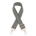Detail of adjustable black and white herringbone bag strap with light gold metal clasps - Black & White