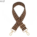 Detail view of the wide woven strap featuring orange geometric scales and gold metal clips - K-17