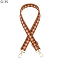 Detail of adjustable woven strap with orange checkerboard pattern and gold hardware - Brown (G-35)
