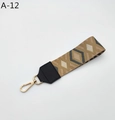 Detail of woven geometric strap with leather ends and golden metal lobster clasps - Khaki Rhombus With Black Faux Leather (A-12)