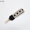 Detail of woven geometric wrist strap with black leather end and gold lobster clasp - Cream Black Rhombus With Black Faux Leather (A-14)