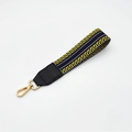 Detail of woven bag strap with yellow black patterns and gold lobster clasp - Silver Clasp / Black Yellow Stripe + Black Leather