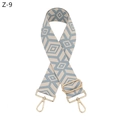 Detail of blue and beige geometric diamond pattern wide woven bag strap with gold hardware - Light Blue With Gold Buckle