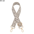 Close-up of geometric diamond pattern on grey and cream woven bag strap with gold clips - M-10 Gray Silver Buckle