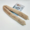 Detail view of khaki faux fur bag strap with gold metal hooks on white surface - Khaki