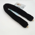 Detail of black faux fur bag strap with gold metal lobster clasps on a white surface - Black