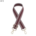 Close-up of wine red and white striped wide fabric strap with gold metal lobster clasps - Gold Buckle / Brown