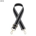 Detail of adjustable black and white striped bag strap with gold metal lobster clasps - Gold Buckle / Black