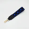 Detail of black wristlet strap featuring blue star pattern and gold lobster clasp - No.7 Black Blue Star
