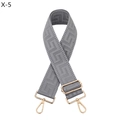 Close-up of gray woven bag strap with geometric jacquard pattern and gold metal hooks - Gray
