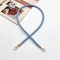 Close-up of light blue PU leather handbag strap with golden hexagonal carabiners - Light Blue