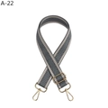 Detail of adjustable herringbone pattern bag strap with polished gold metal buckles - Gray