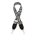 Detail of adjustable leopard print bag strap with black leather ends and gold metal clips - Black and White Leopard Print