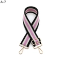 Detail view of woven black and purple adjustable bag strap with gold metal hardware - A-7 Black Pink Striped