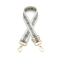 Close-up of snowflake pattern woven strap with gold metal lobster clasps and buckle - Gray