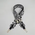 Detail of adjustable geometric jacquard bag strap with gold metal hooks and black leather - Black and White Jacquard