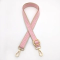 Detail of adjustable pink geometric jacquard bag strap with golden metal swivel hooks - Pink