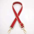 Detail of red geometric woven strap with gold metal hooks and adjustable buckle - Red