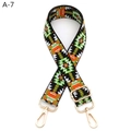 Detail view of colorful jacquard guitar style purse strap with gold lobster clasps - A-7 Black Green Orange