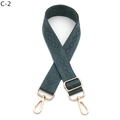 Close-up of deep green diamond pattern woven bag strap with golden metal lobster clasps - Gold Buckle / Malachite green